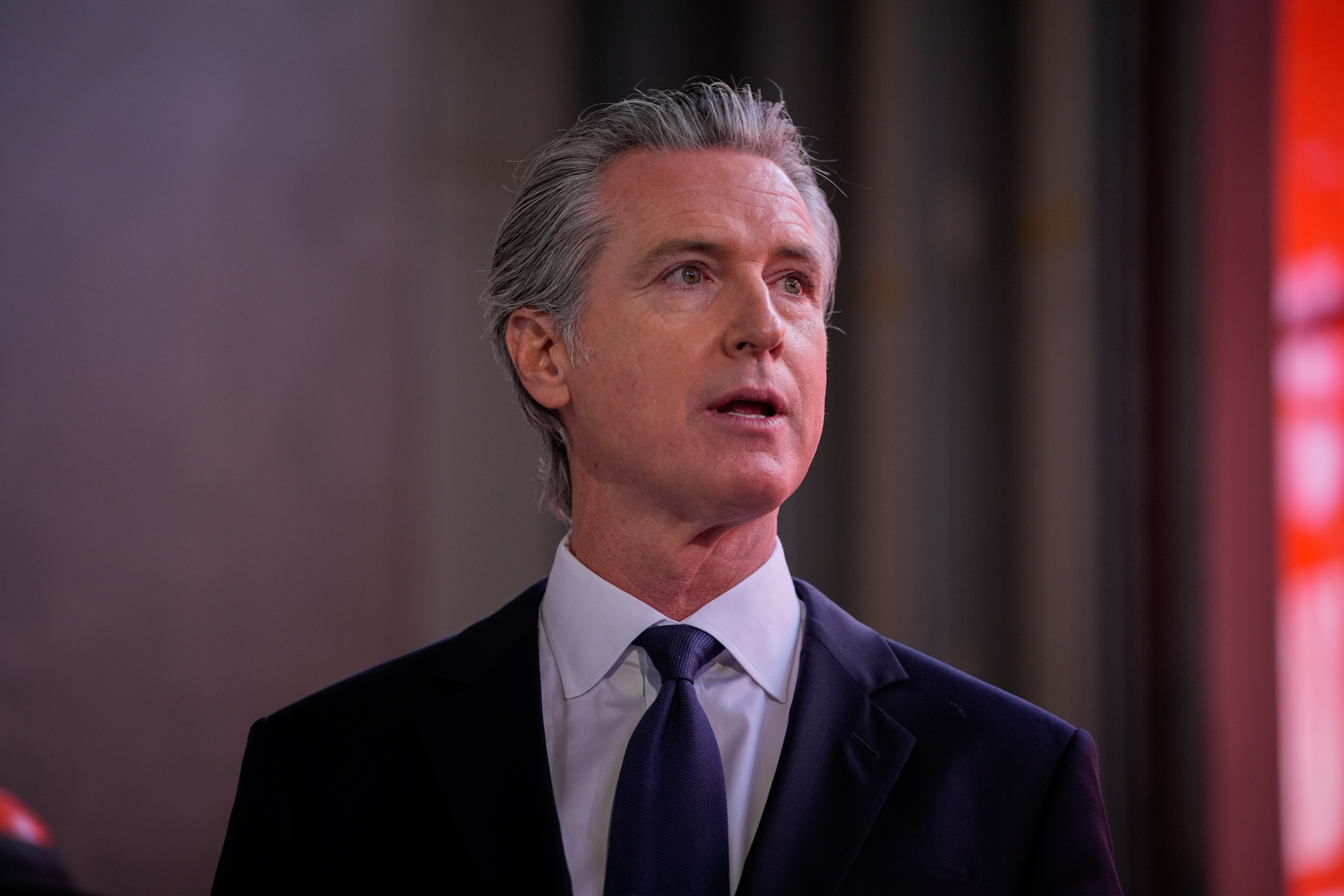 A idiosyncratic successful a suit and necktie appears to beryllium speaking, perchance astatine an lawsuit oregon interview, with blurred inheritance elements