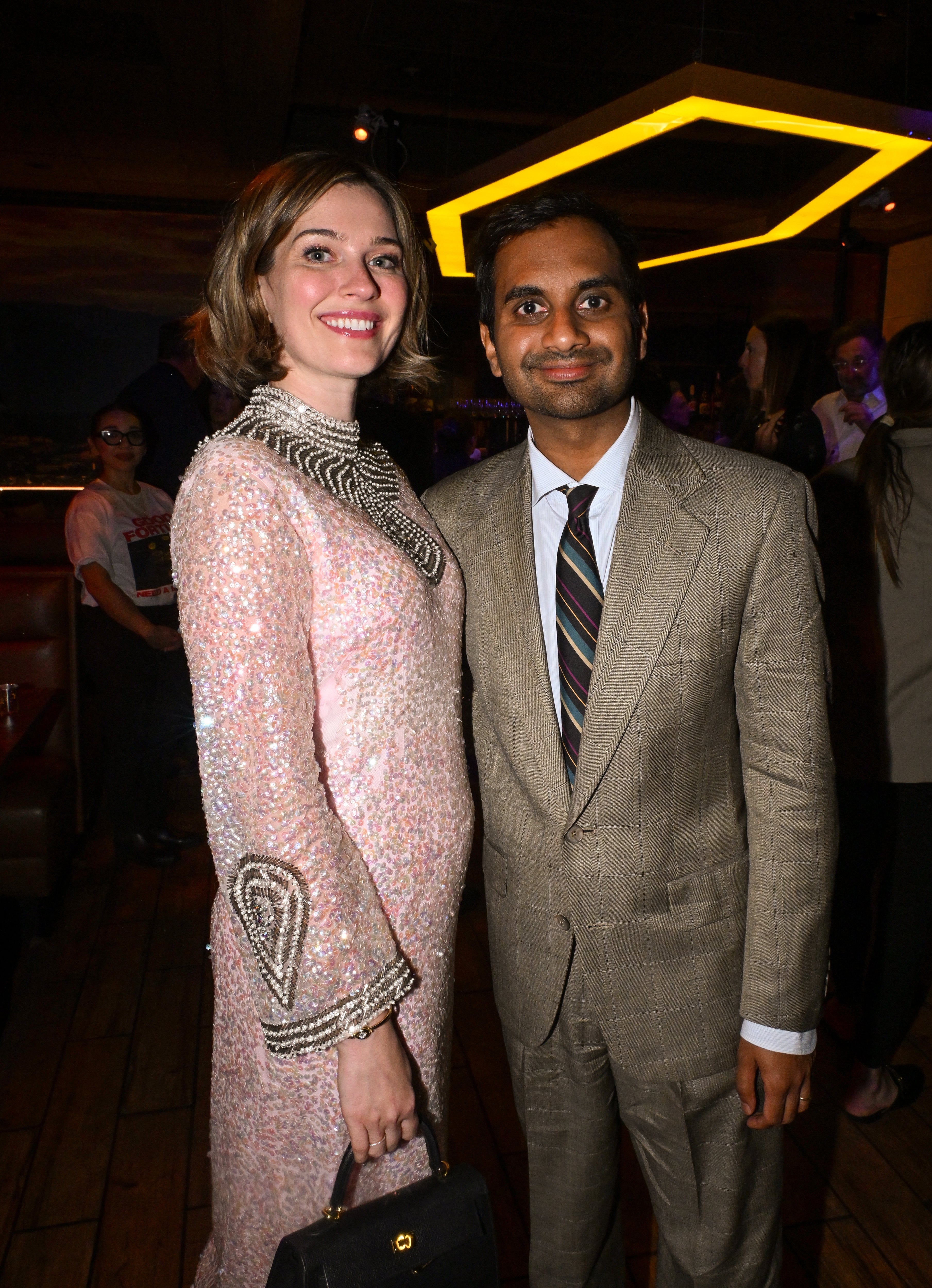 Serena Skov Campbell and Aziz Ansari posing at an event