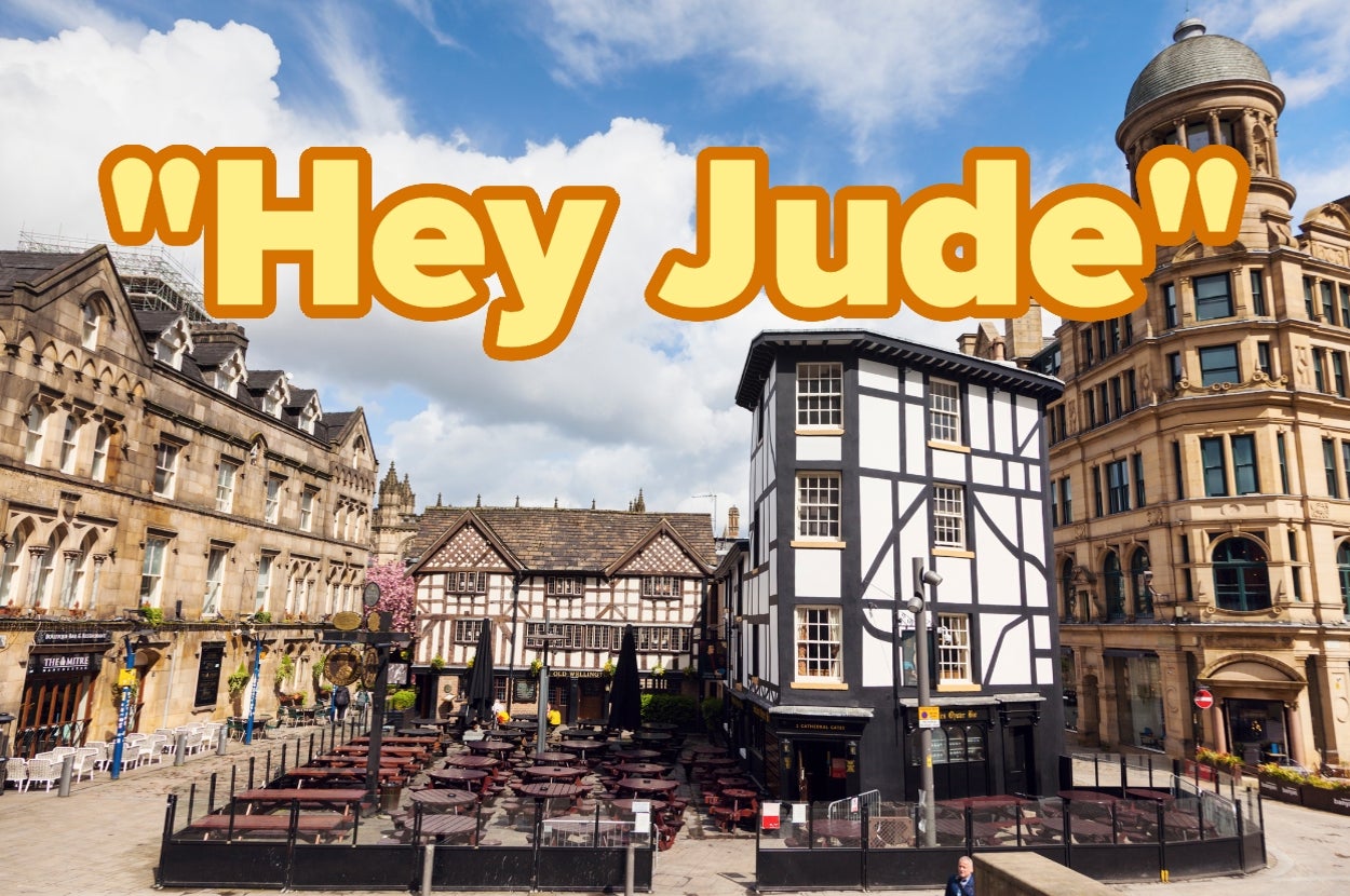 Town square with historic buildings and a pub, overlaid with large text "Hey Jude."