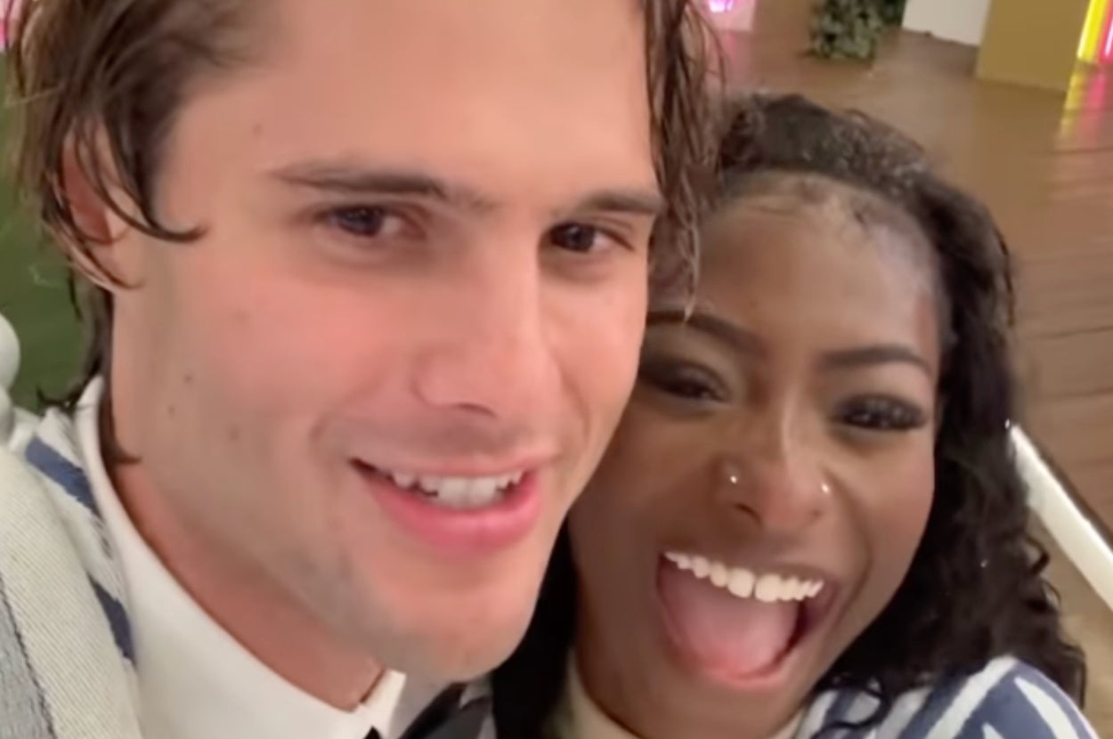 Two people smiling closely for a selfie, appearing joyful and excited