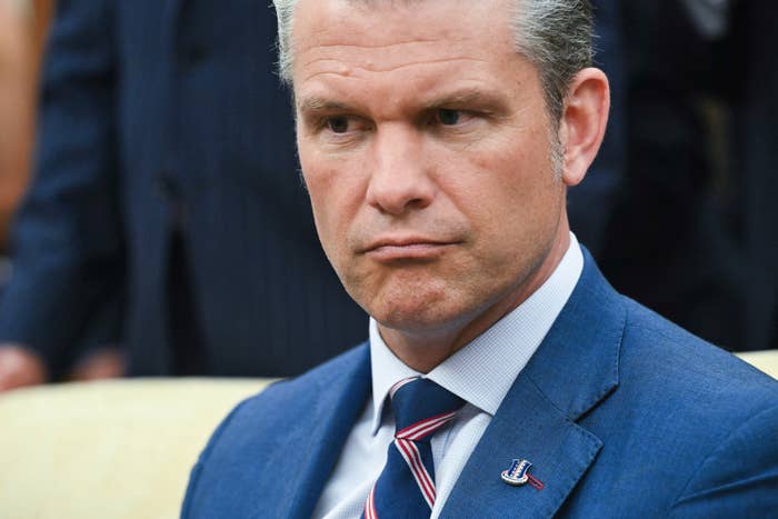 Person successful  a suit   with a striped tie, looking intently