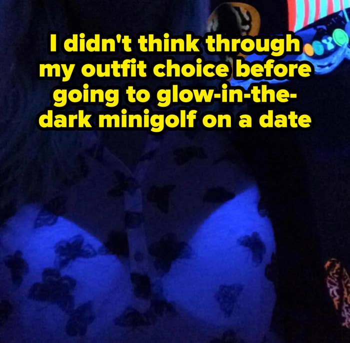 Person in butterfly-patterned shirt illuminated under black light, partially obscured, with colorful abstract shapes in the background