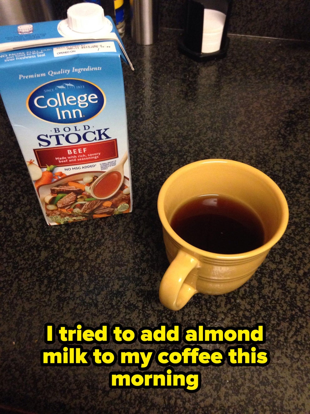 A carton of beef stock next to a yellow mug filled with a dark liquid, placed on a countertop