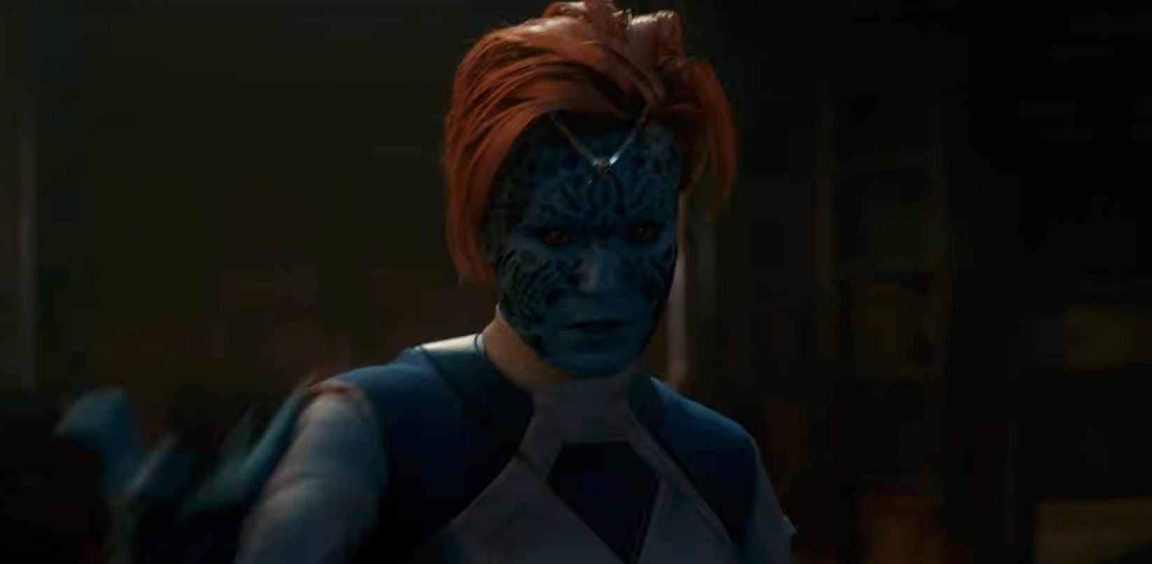 Person in intricate blue makeup and costume, portraying a fictional character from a movie