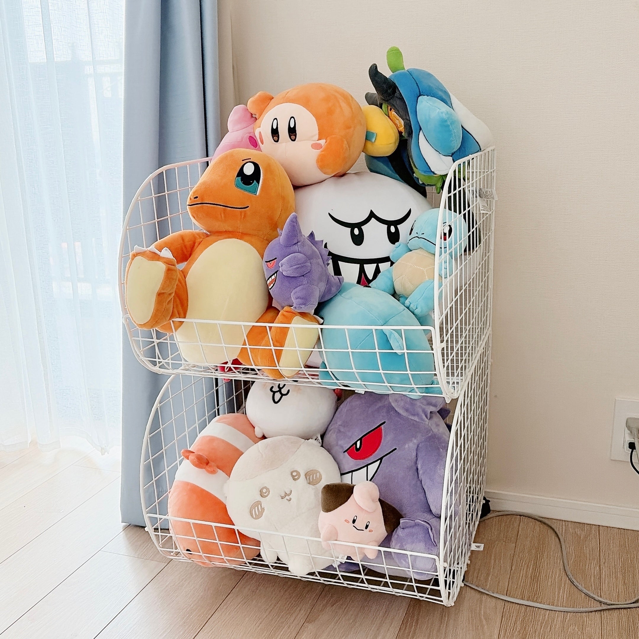 複数のかわいいぬいぐるみがワゴンに並べられた、明るい部屋の一角。