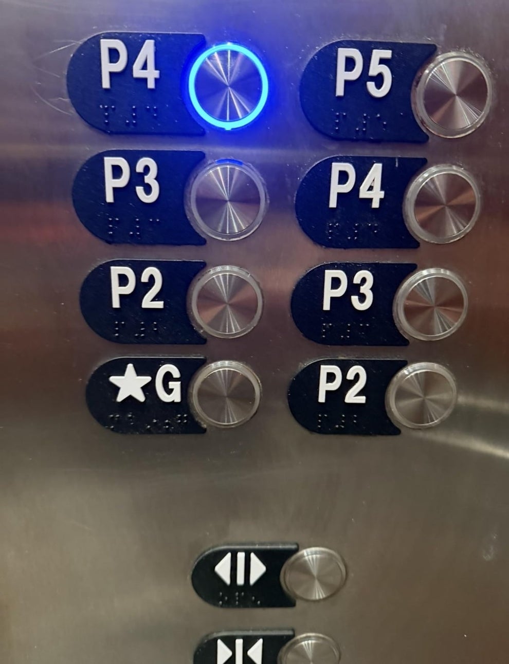 Elevator panel with duplicate floor buttons: P4, P3, P2, P5, and star for ground. P4 is selected with a light