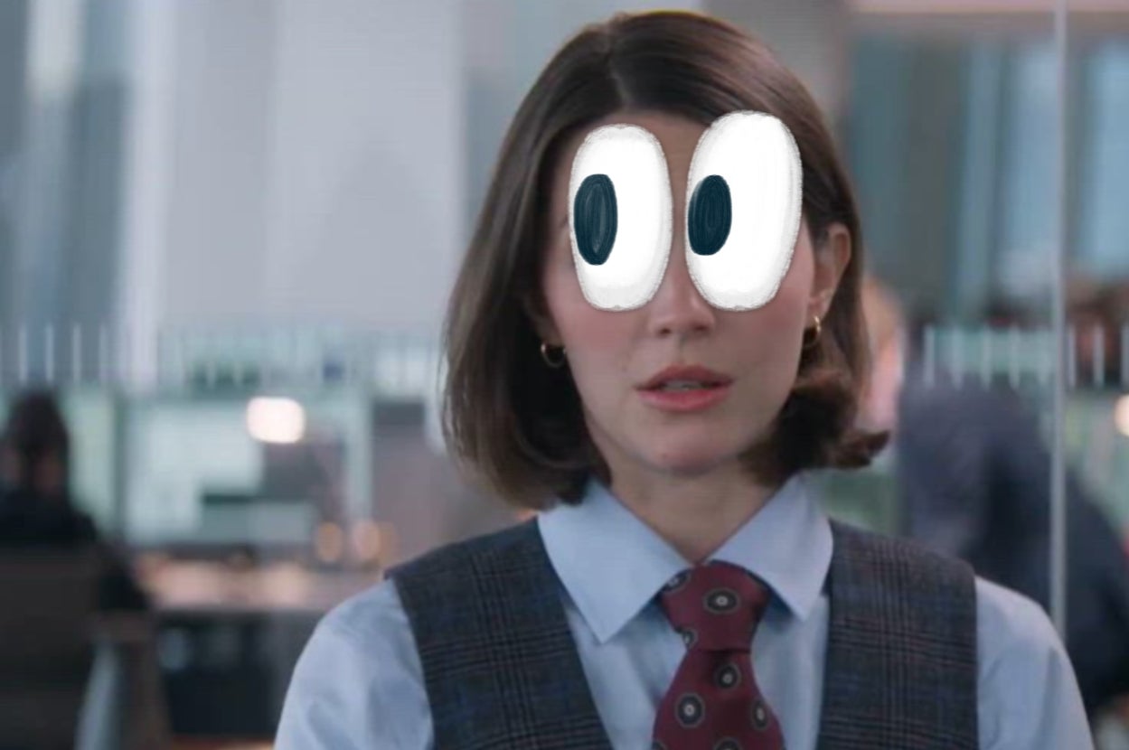 Person in office attire with cartoon eyes superimposed, standing indoors with a blurred office background