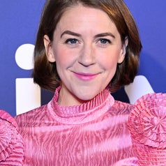 Gemma Whelan wearing a high-necked, textured pink outfit with pleated details on the shoulders