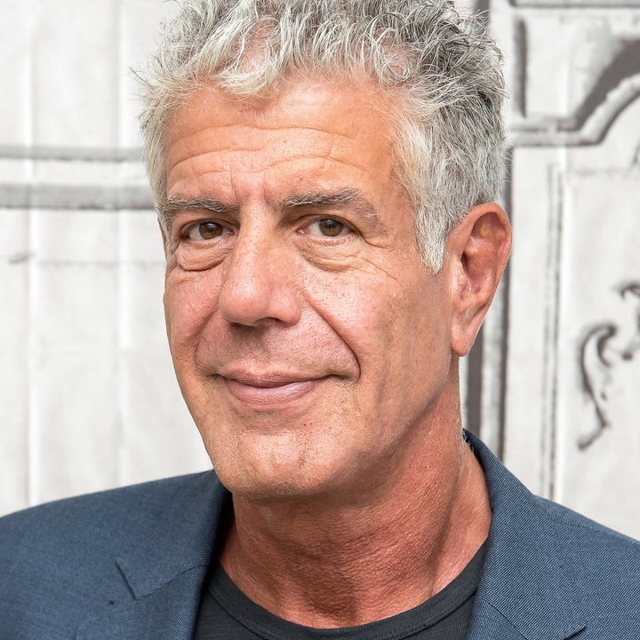 Anthony Bourdain wearing a dark jacket and a subtle smile