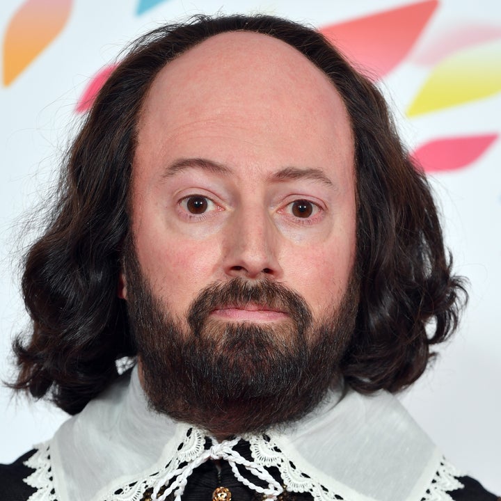 David Mitchell dressed in an Elizabethan-style black coat with lace collar, attending a formal event
