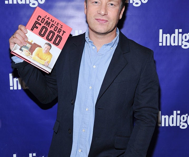 Jamie Oliver holding his book "Jamie's Comfort Food"
