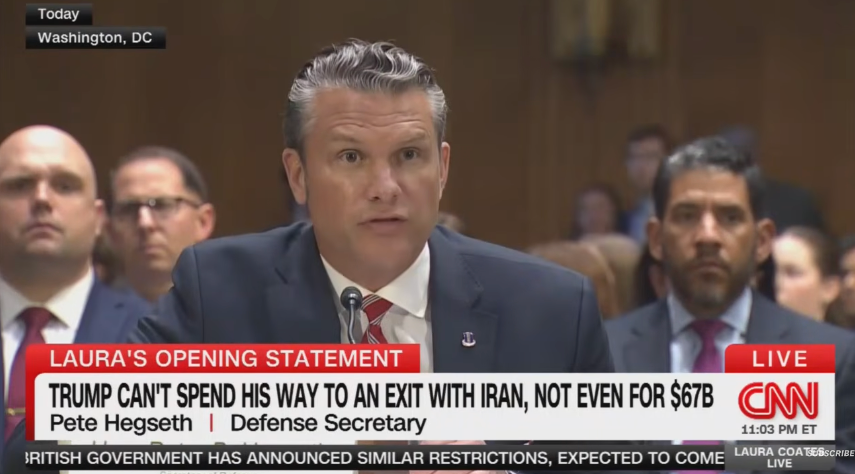 Man in a suit, identified as Defense Secretary, speaks at a hearing. CNN ticker discusses budget concerns related to Iran