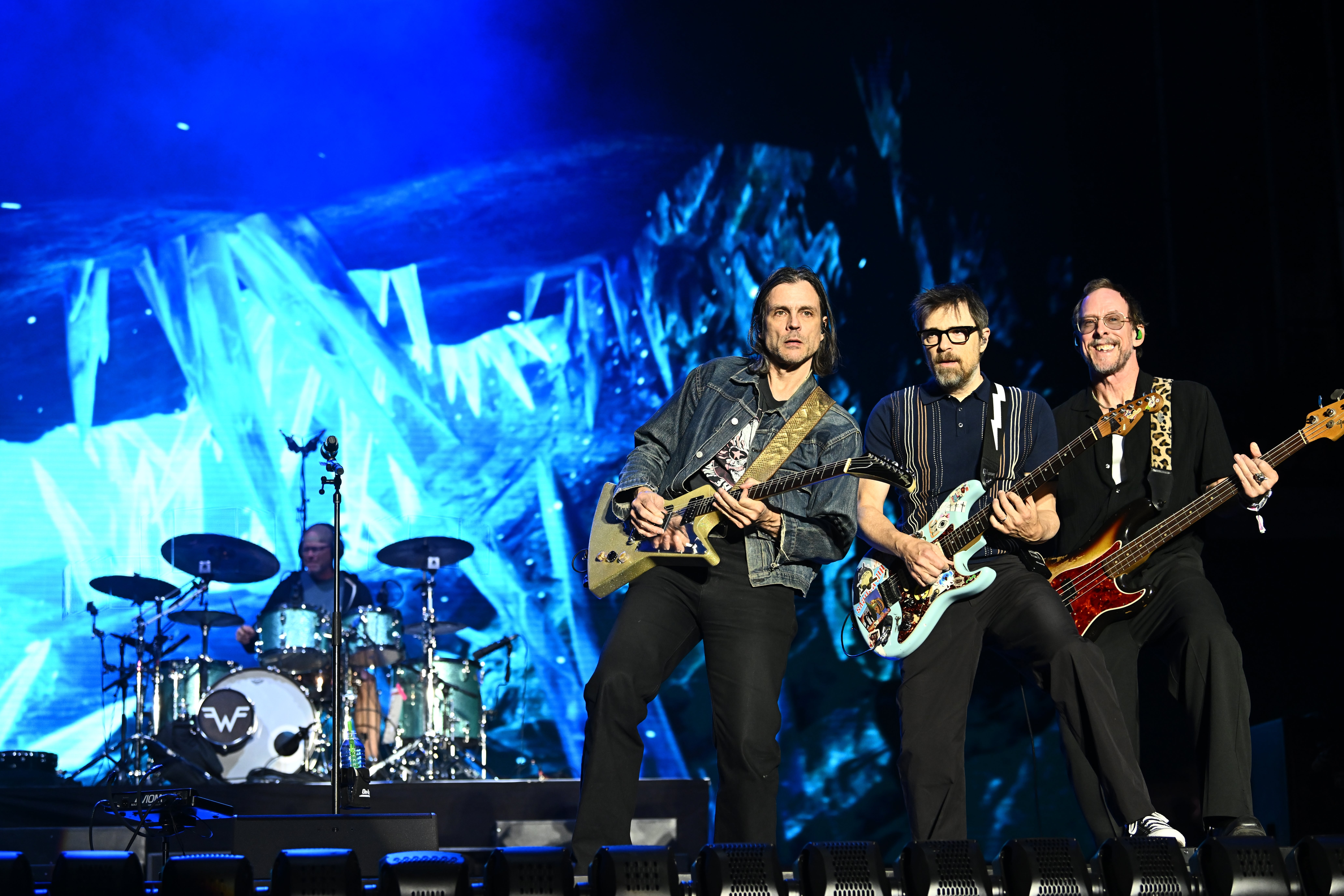 Weezer performing on stage with guitars