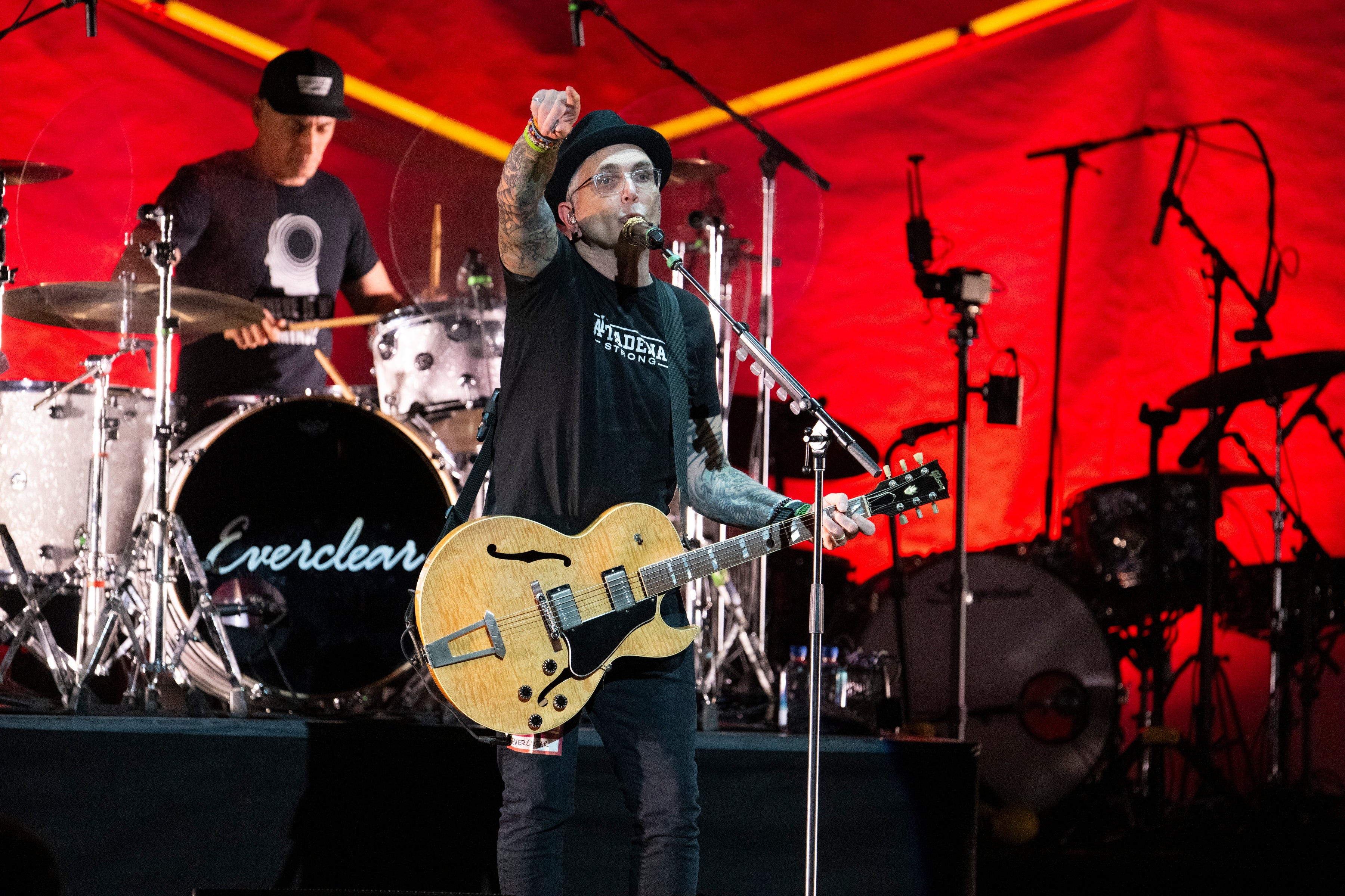 Everclear performs on stage with a guitar