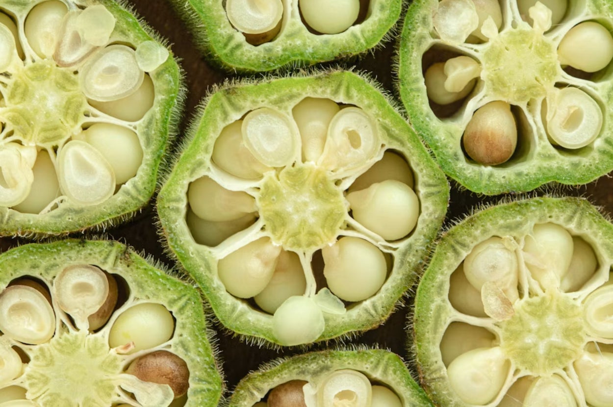A close-up of fresh Brussels sprouts piled together, showcasing their round shape and layered leaves