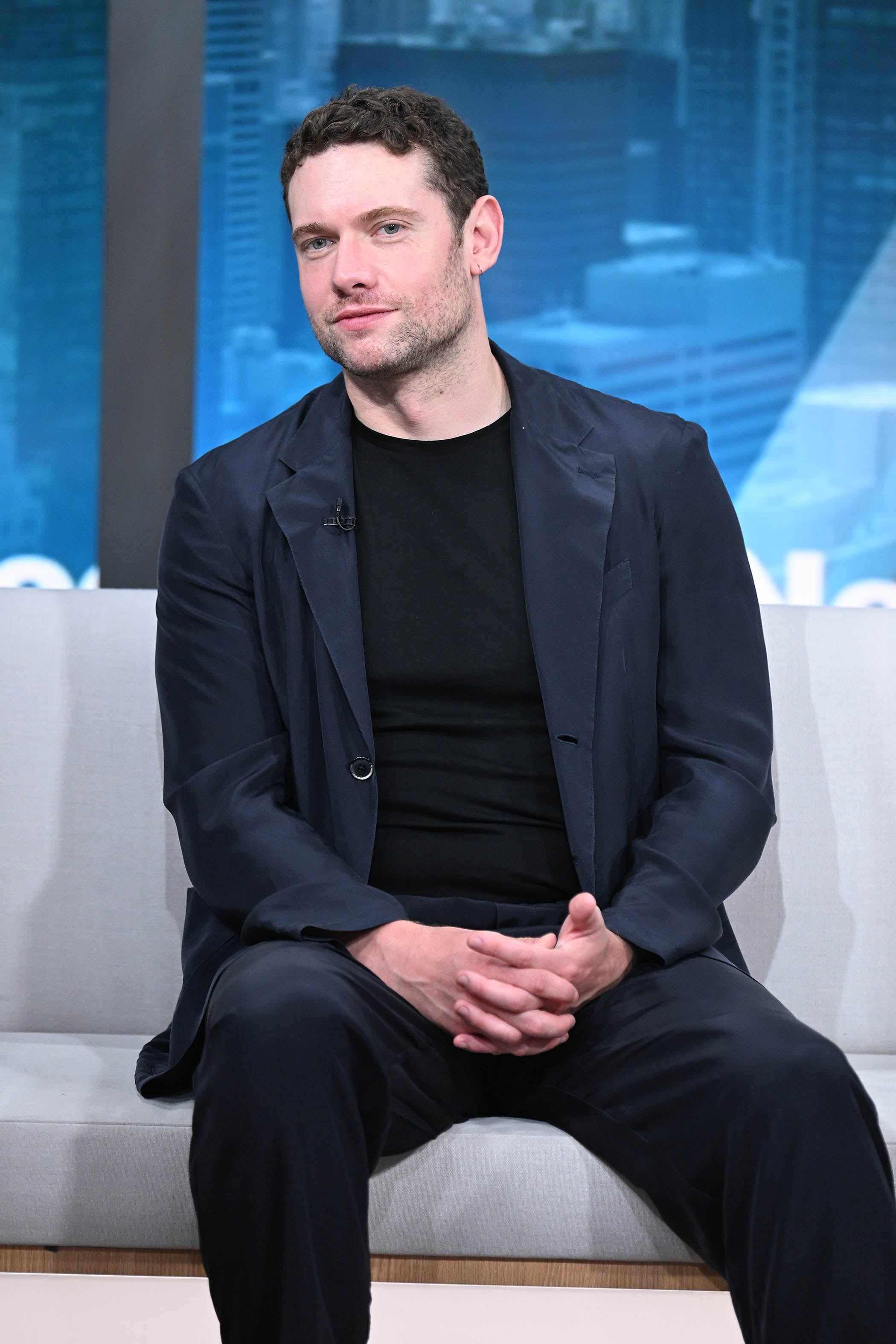 Tom Brittney sitting on a couch