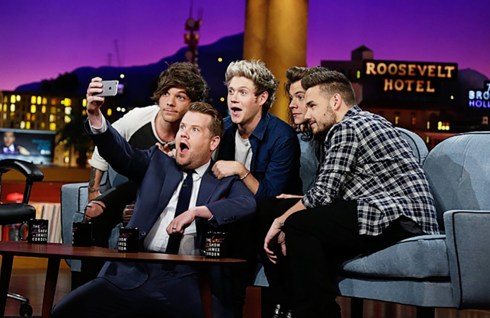 James Corden takes a selfie with the band One Direction on the set of The Late Late Show