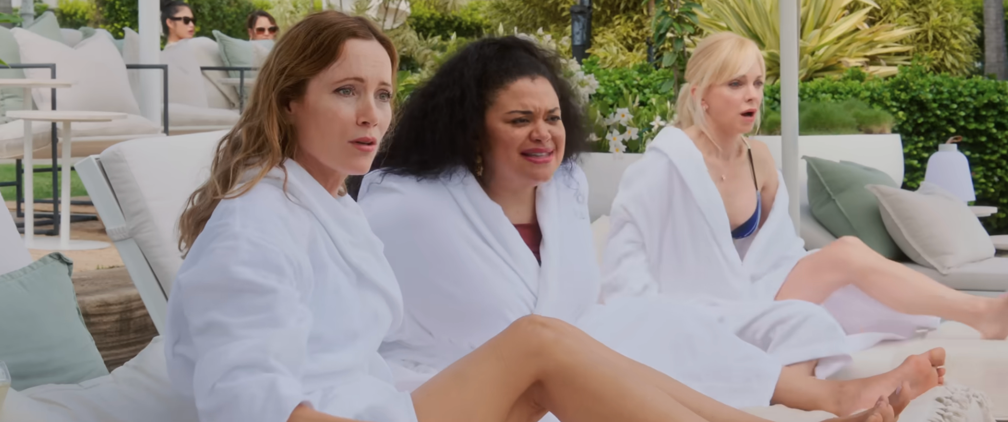 Three women in bathrobes sitting outside in "Spa Weekend"
