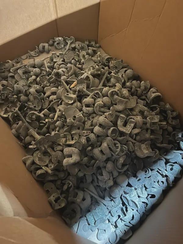 Box filled with assorted, small metal or plastic industrial parts