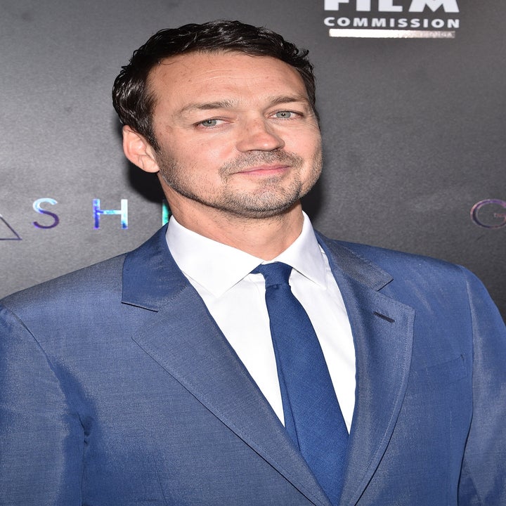 Man in a formal suit and tie at a celebrity event