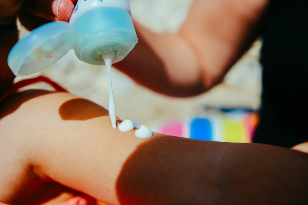 Person applying lotion on their arm