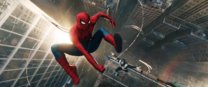 Spider-Man and another figure swing between skyscrapers, showcasing their agility in an urban setting