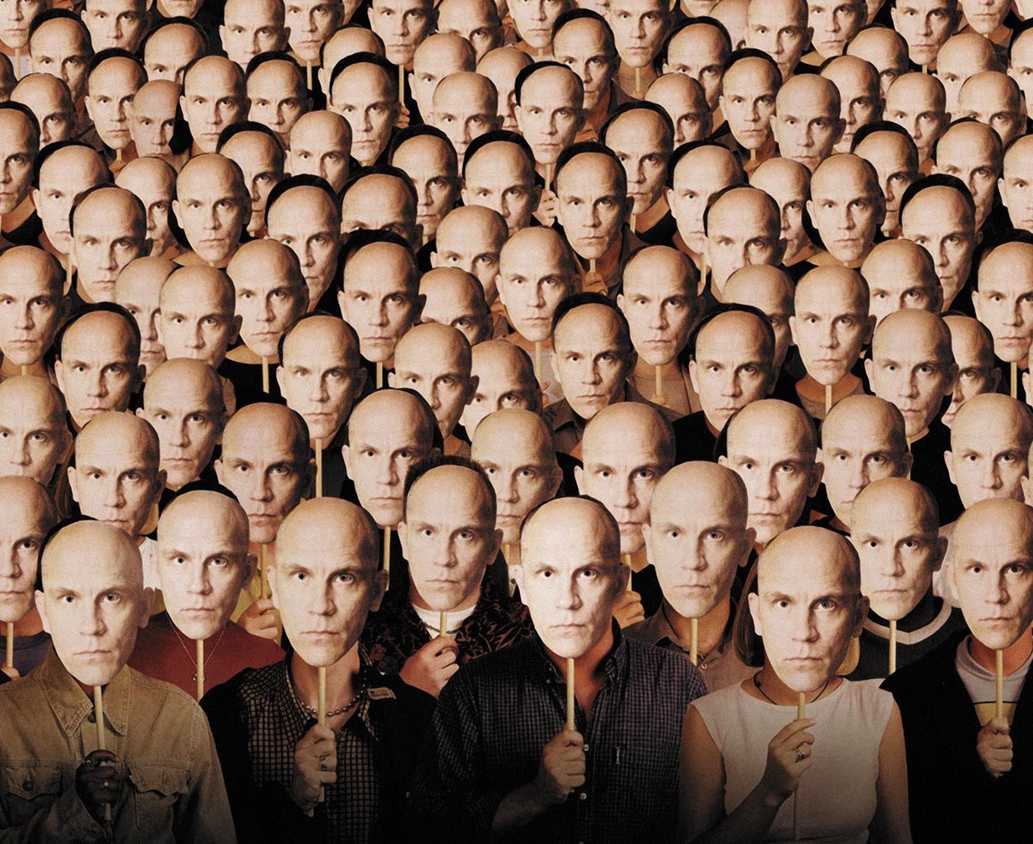 Crowd of people all holding a mask of John Malkovich to their faces