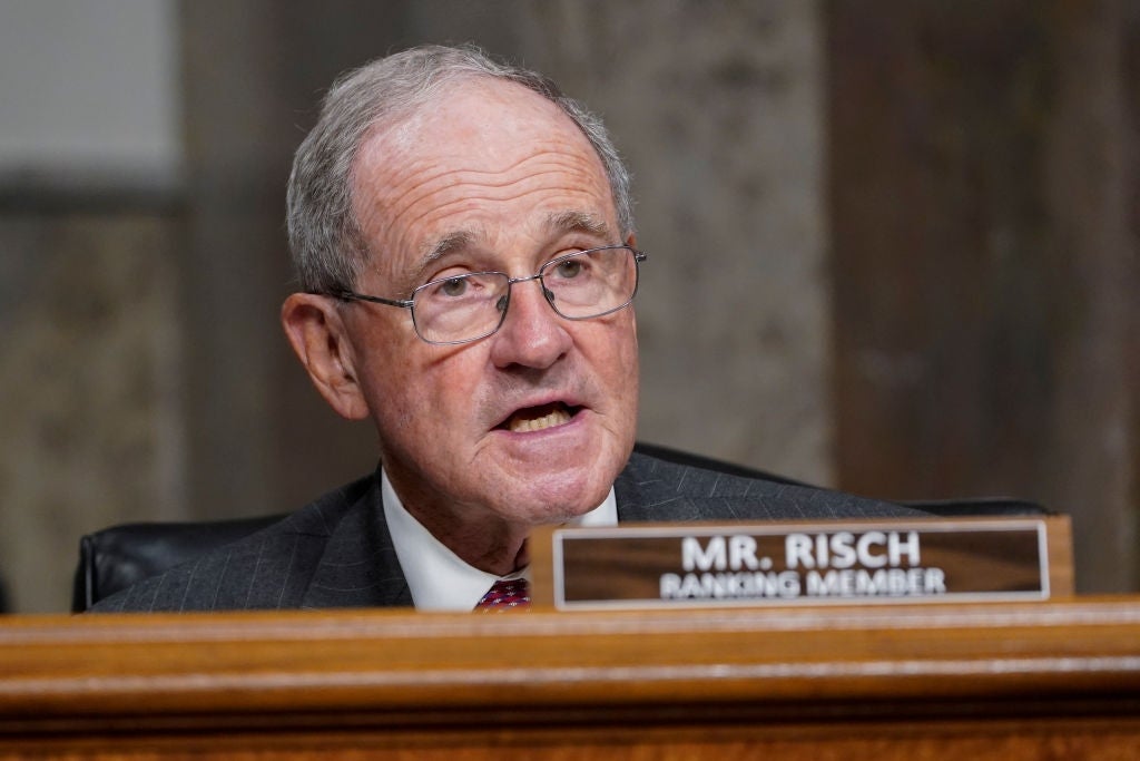 Jim Risch in a suit speaks at a podium with a nameplate reading "Mr. Risch Ranking Member."