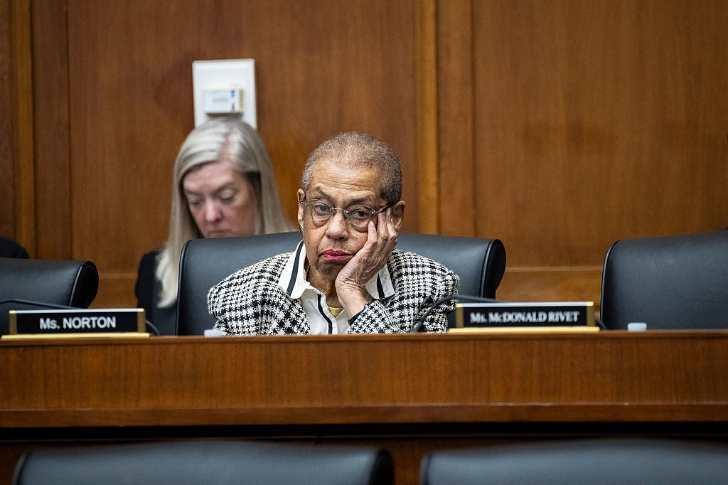Eleanor Holmes Norton sits at a panel, resting her face on her hand
