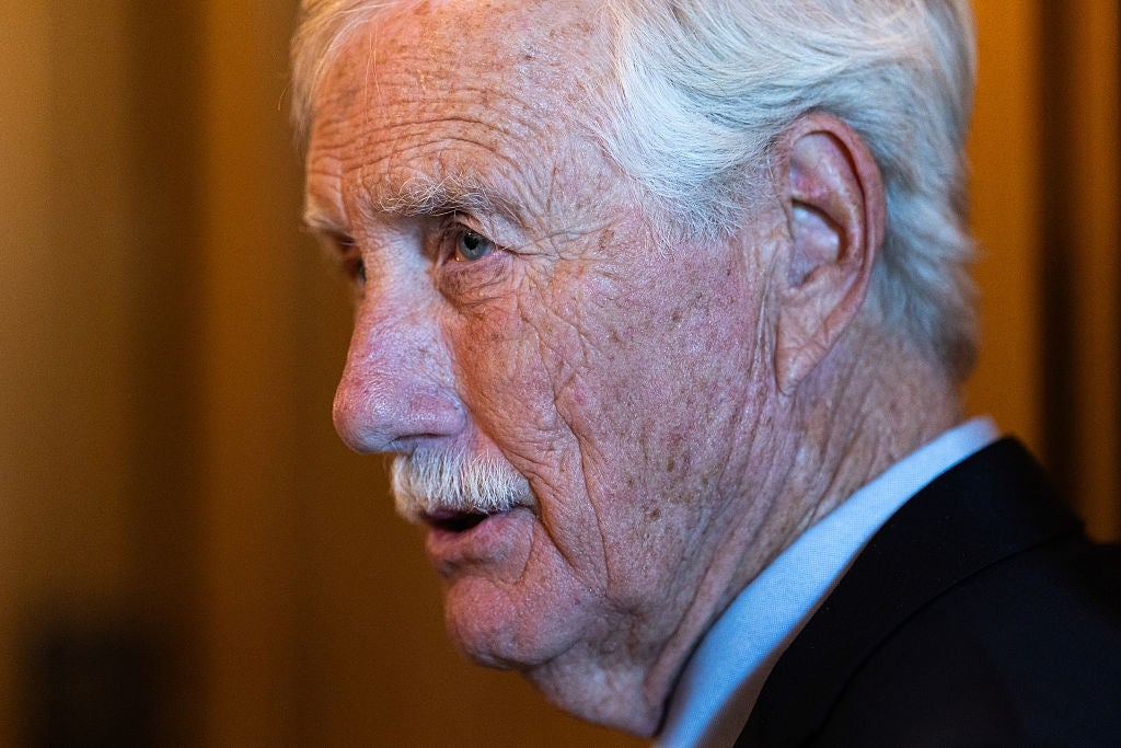 Angus King with mustache in a suit, profile view