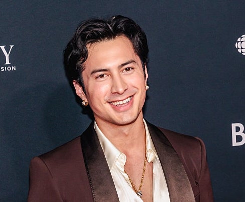 Person on the red carpet wearing a tailored suit with a silky shirt, smiling at the event for the Academy of Canadian Cinema & Television