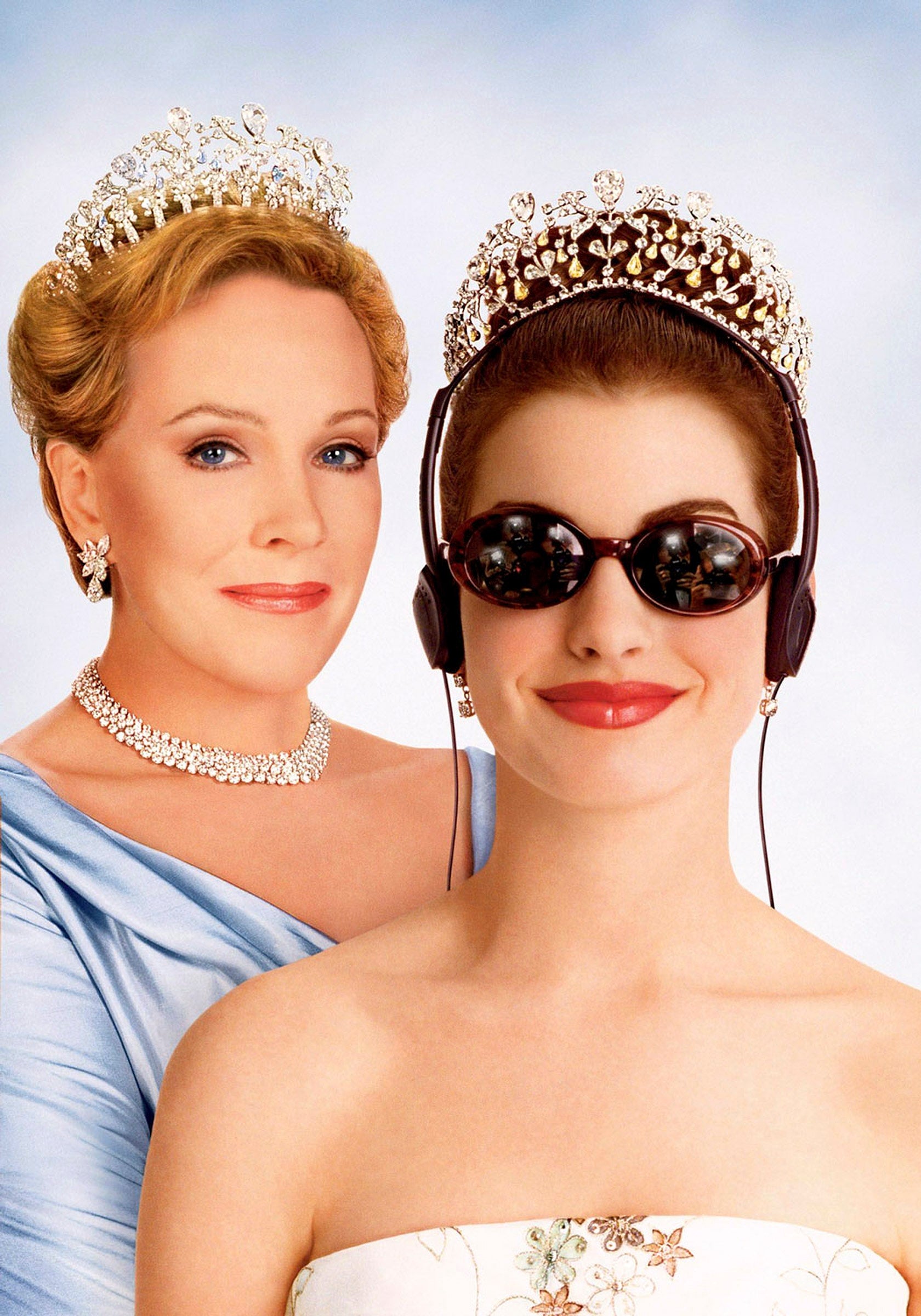 Two women wearing tiaras. The woman in front wears sunglasses and headphones; the woman behind wears an elegant gown and necklace