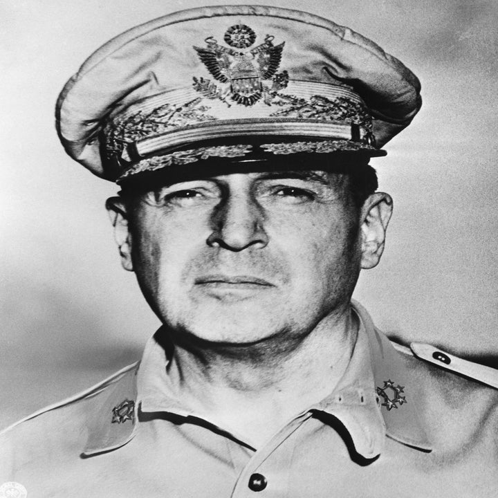 A historical figure in military uniform and hat with insignia, looking serious. No identifiable modern celebrities present