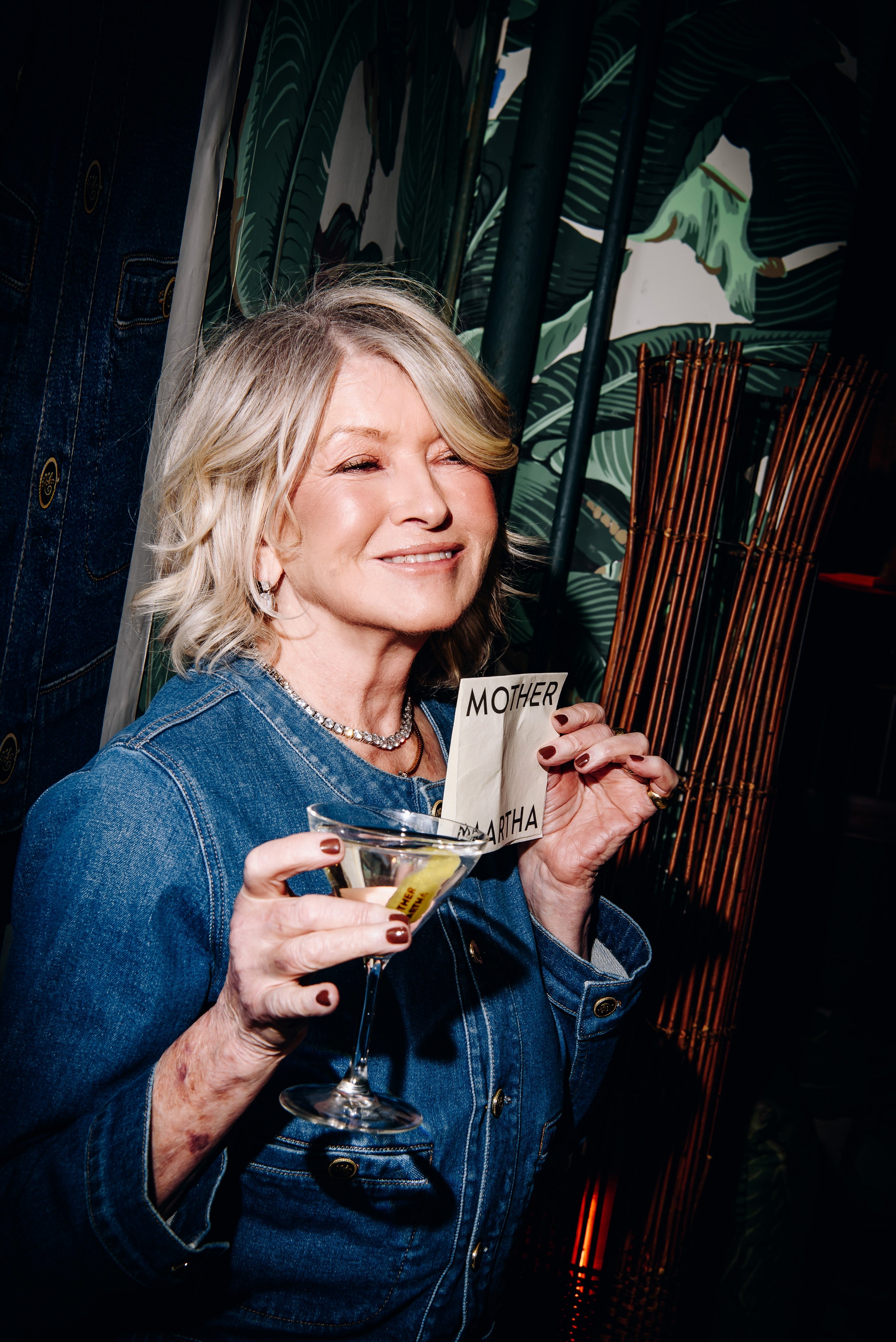 Martha Stewart holding a martini glass with a napkin that says "Mother Martha"