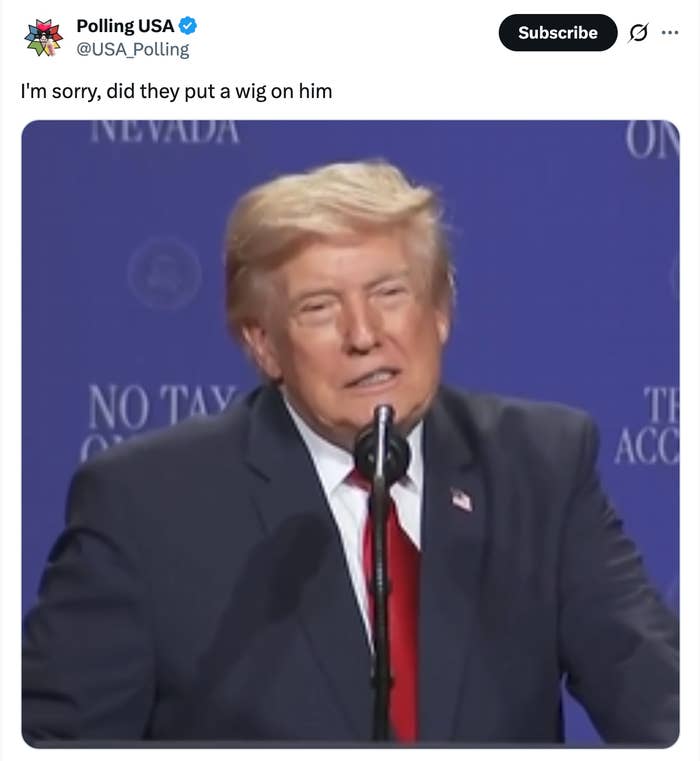 A person in a suit speaking at a podium, with a humorous caption questioning their hairstyle