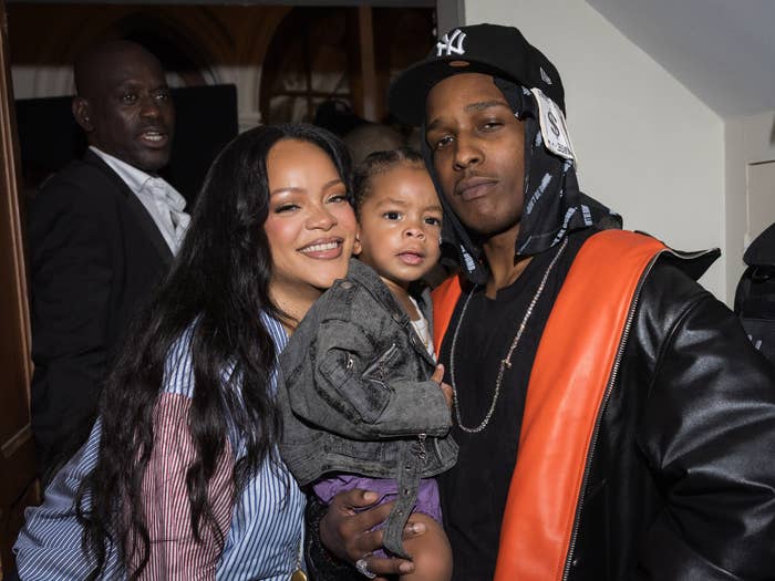 I don’t know who they are, but the image shows three people smiling and posing together at an event. A child is held between two adults