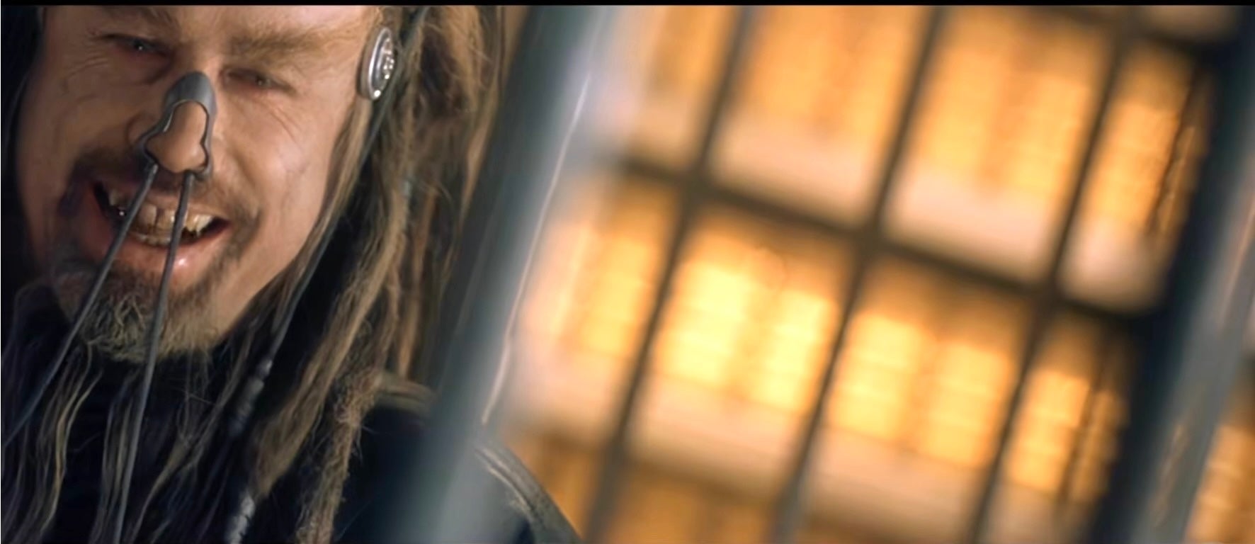 A person with long hair and unique facial adornments in a futuristic setting