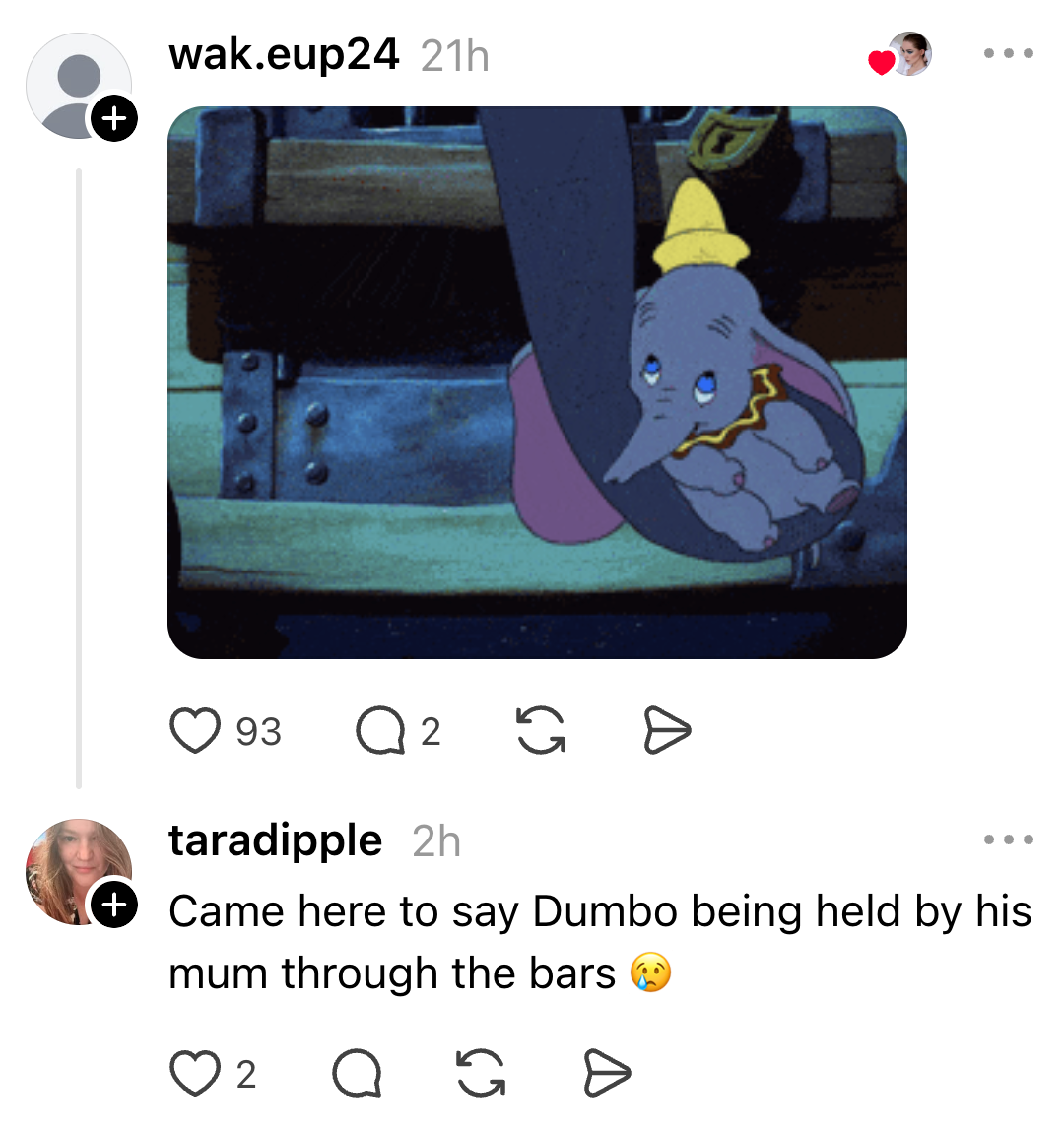 Animated Dumbo looks sad as his mother holds him through the bars