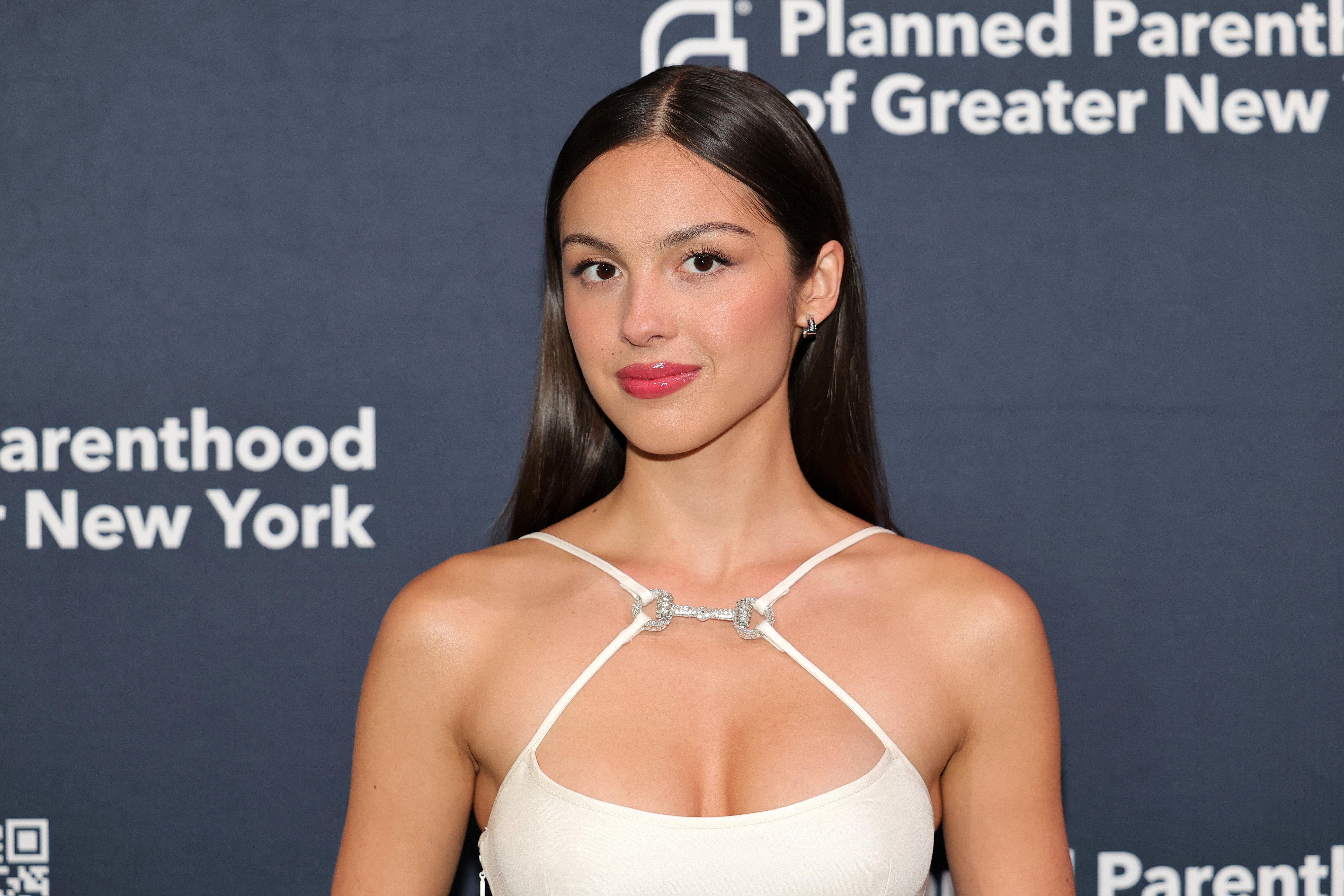 Person in an elegant white dress attending a Planned Parenthood of Greater New York event