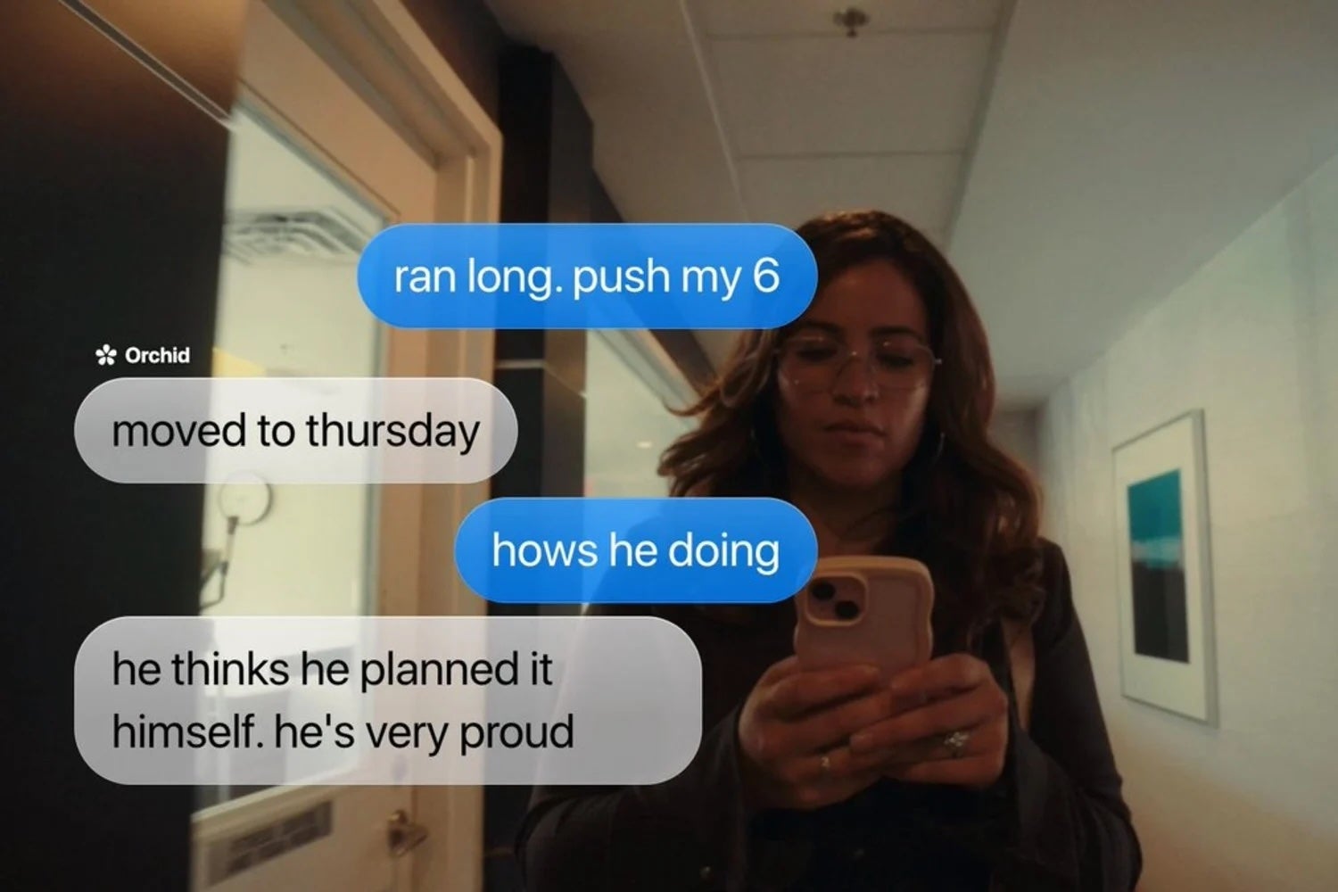A woman reads messages on her phone. Texts discuss rescheduling to Thursday and pride in someone's planning