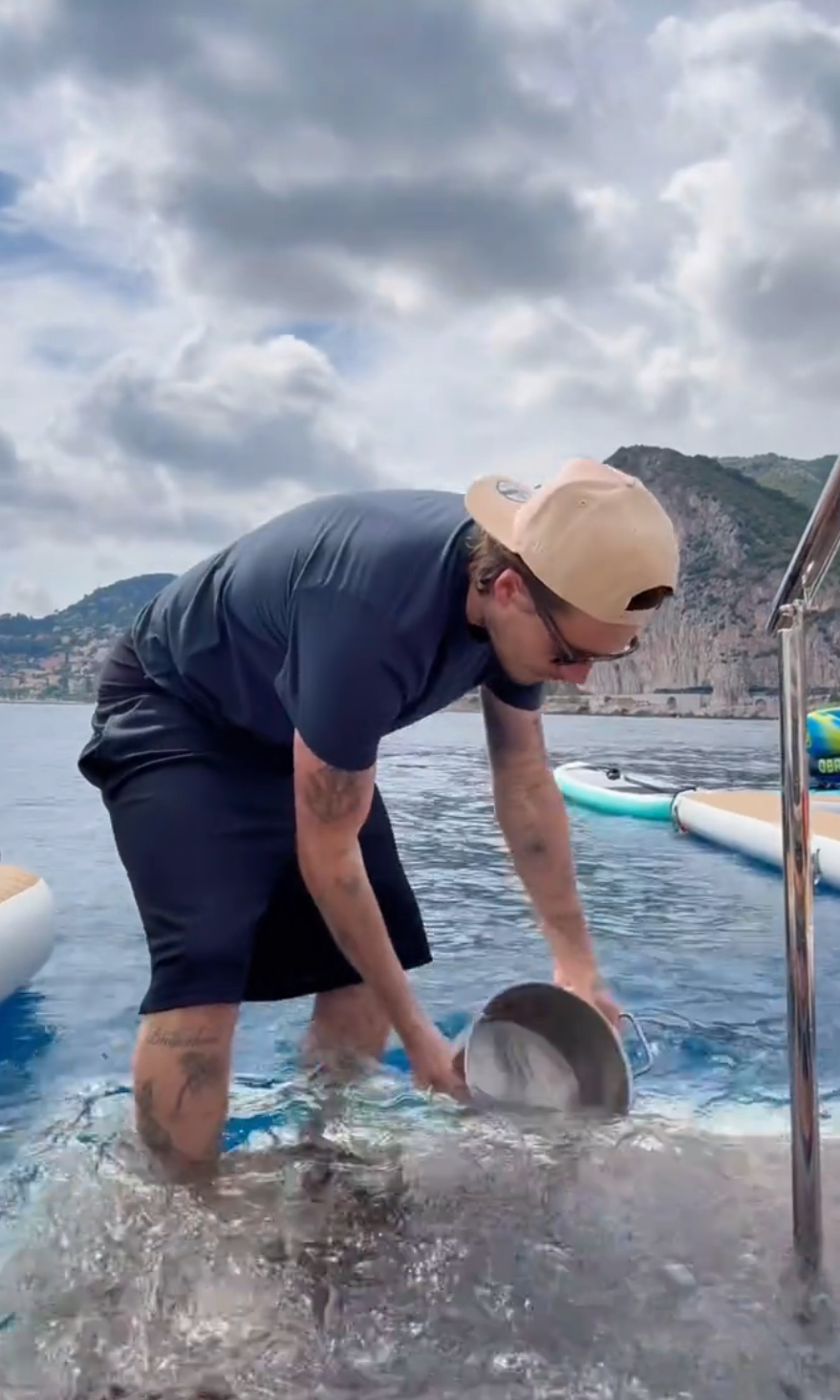 Brooklyn collecting seawater in a pot