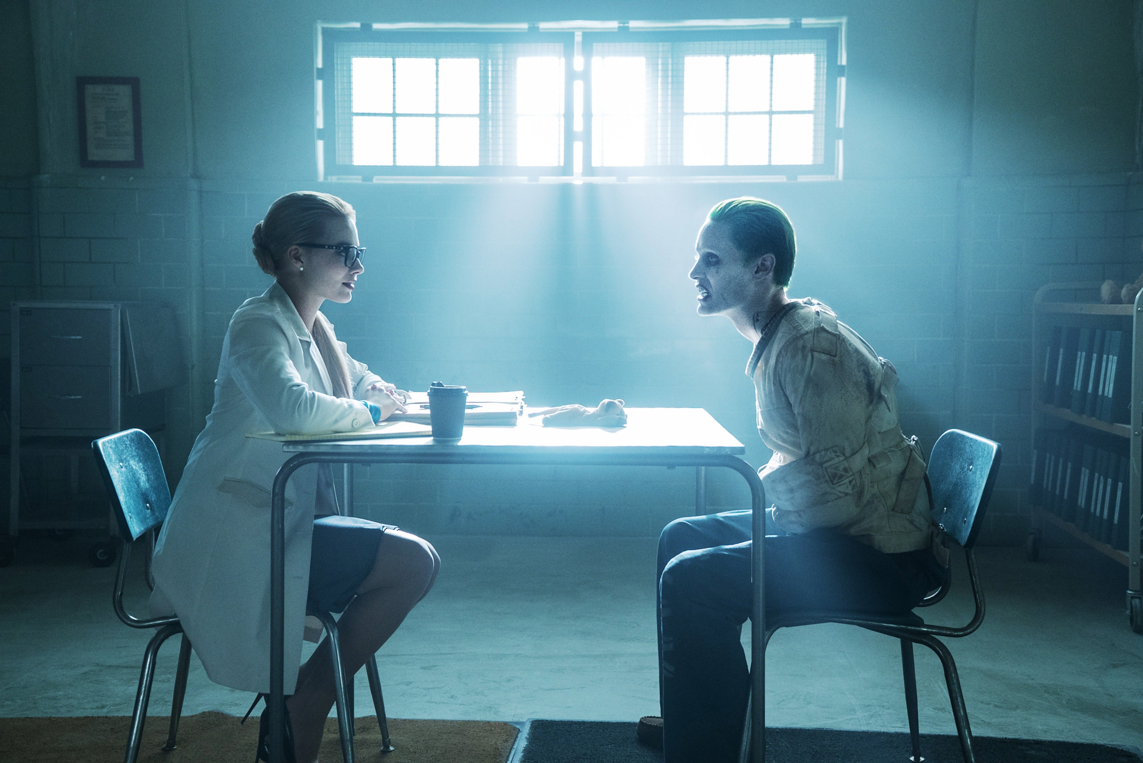 Robbie playing Harley Quinn as a doctor interviewing a straitjacketed Leto as the Joker