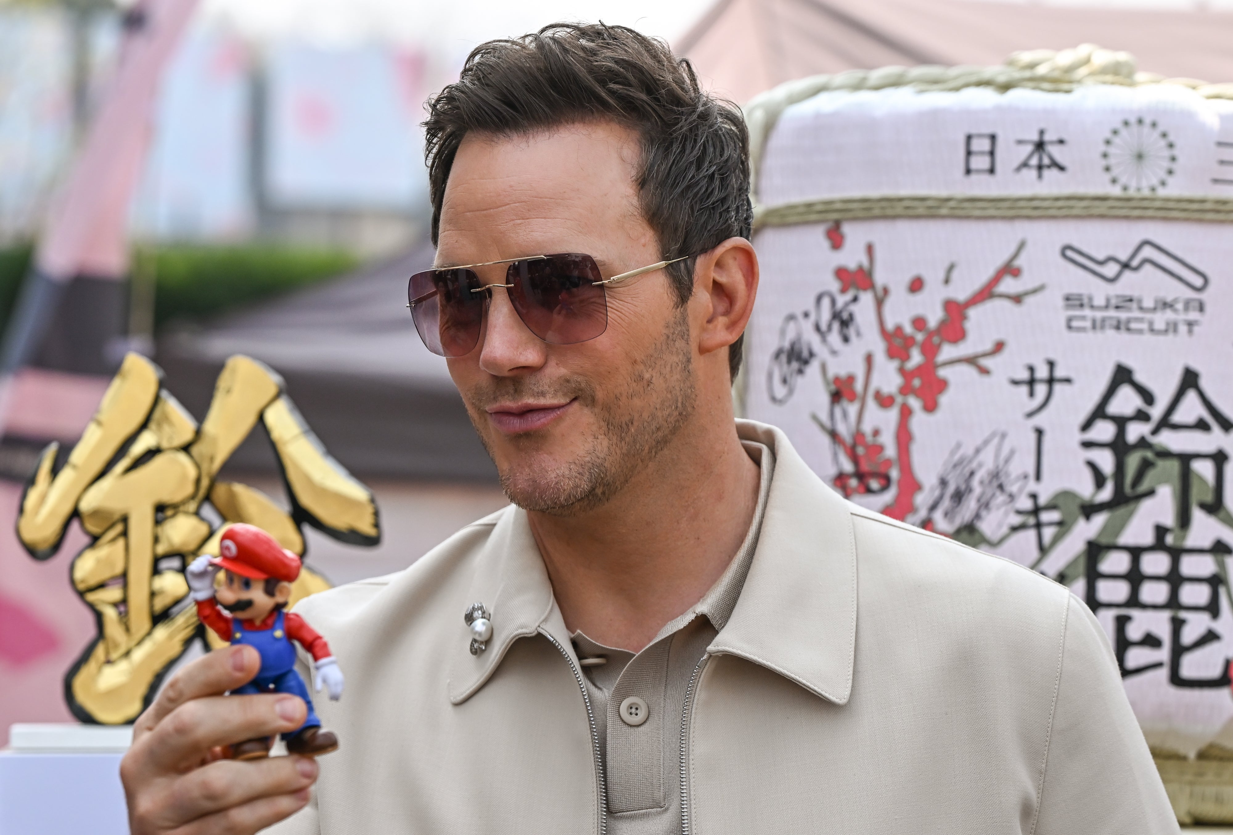 Pratt holding a small Mario figurine