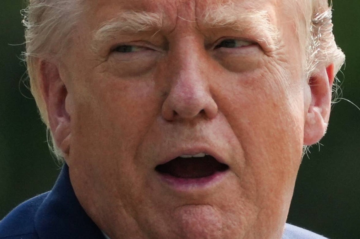 Person outdoors, speaking with mouth slightly open and looking to the side