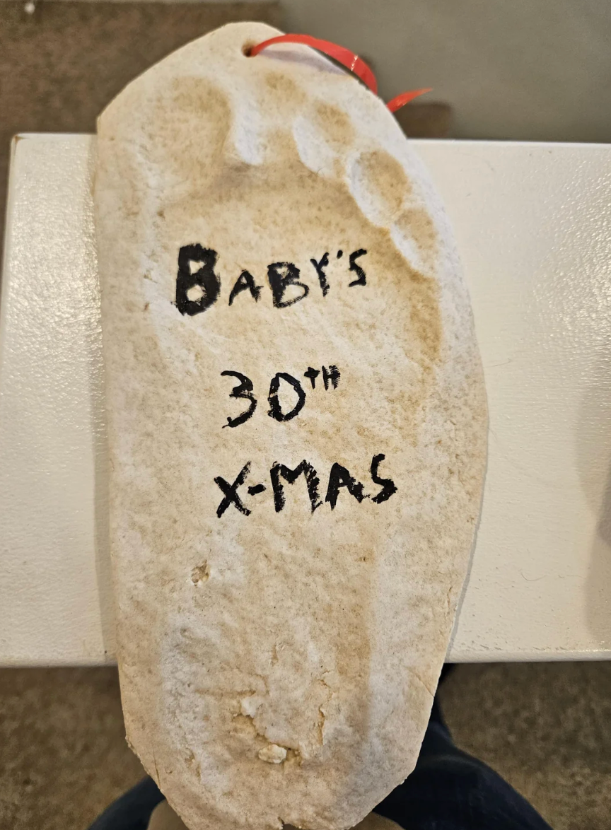 Clay footprint ornament with text: "Baby's 30th X-Mas" written on it