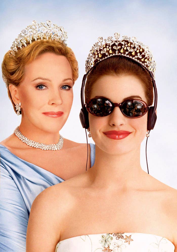 Two women wearing tiaras; one in an elegant off-shoulder dress, the other in sunglasses and headphones
