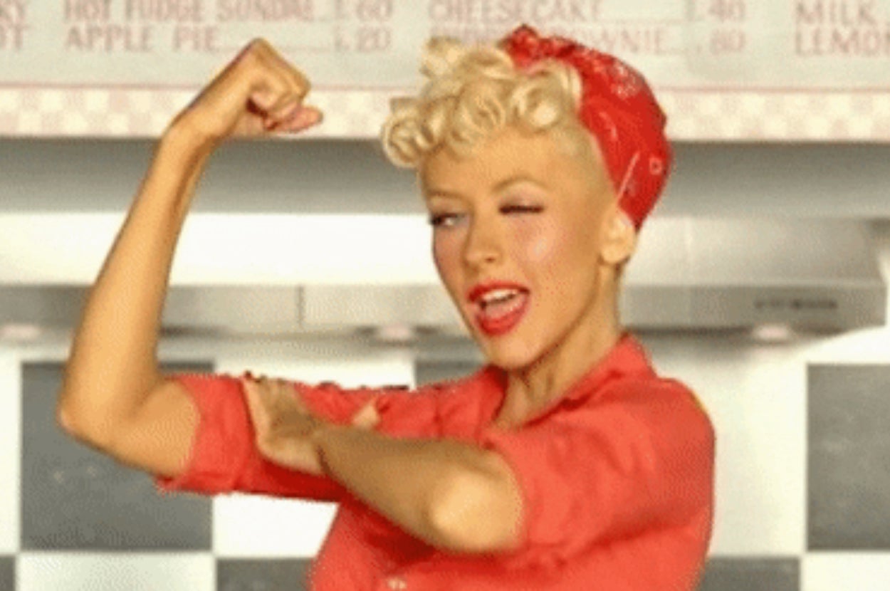 Person in retro style does a strong pose, wearing a bandana and vintage outfit, evoking empowerment