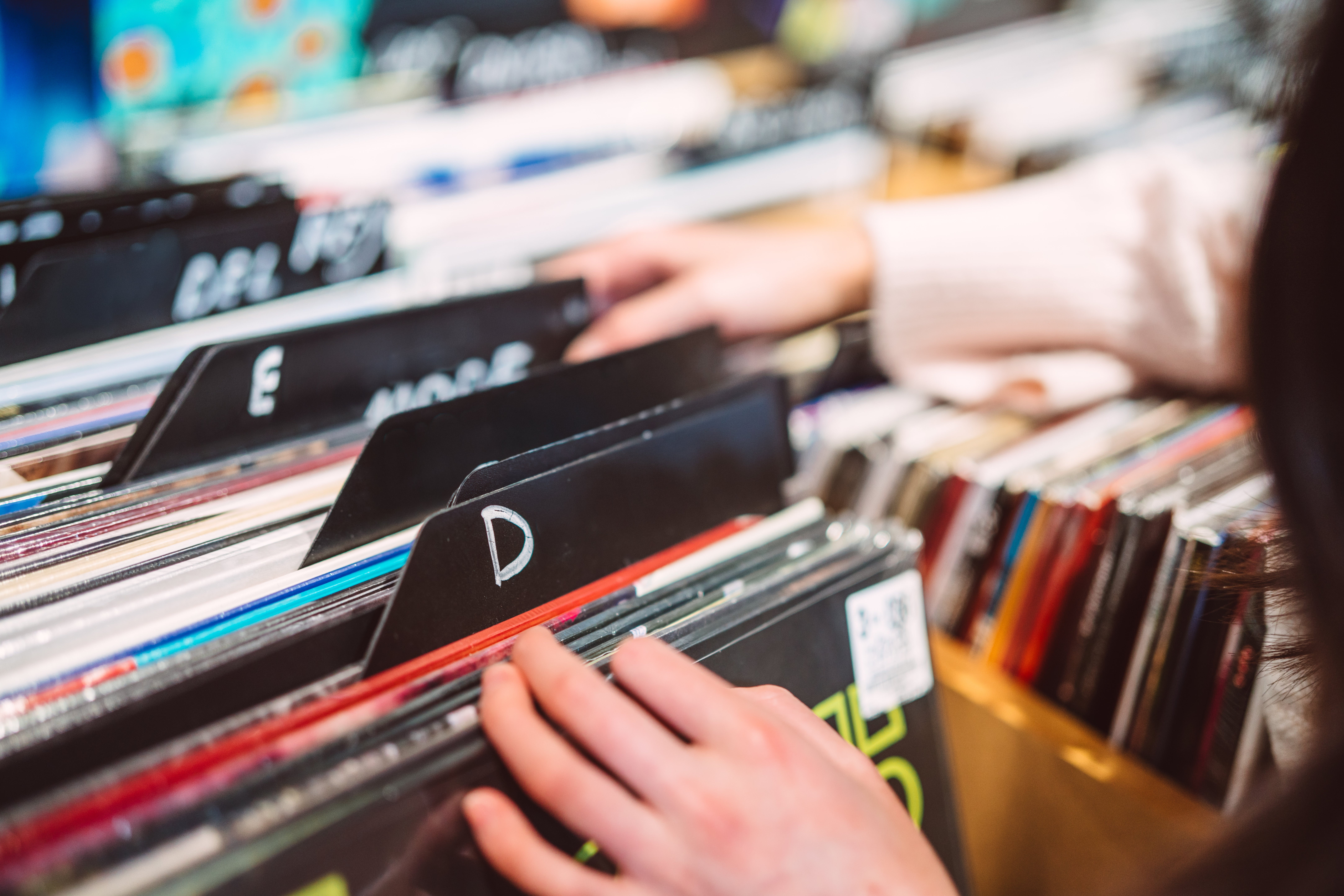 A person looking at vinyl records