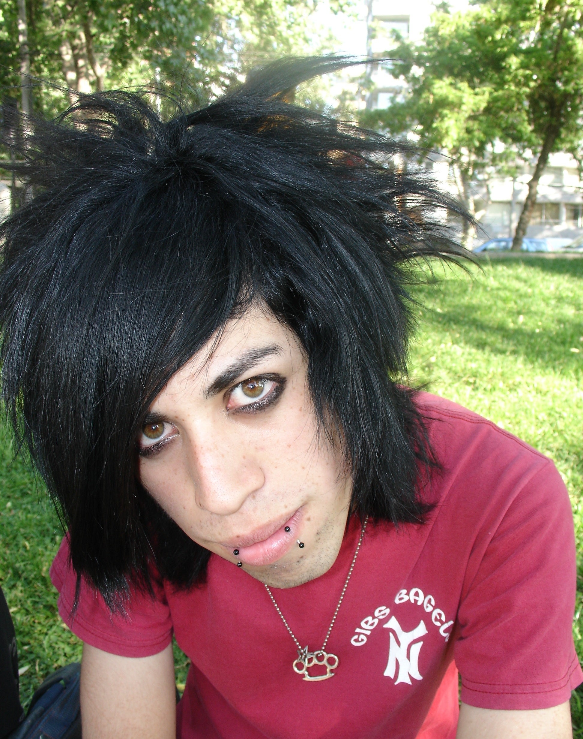 An emo kid with snakebite piercings and a choppy haircut