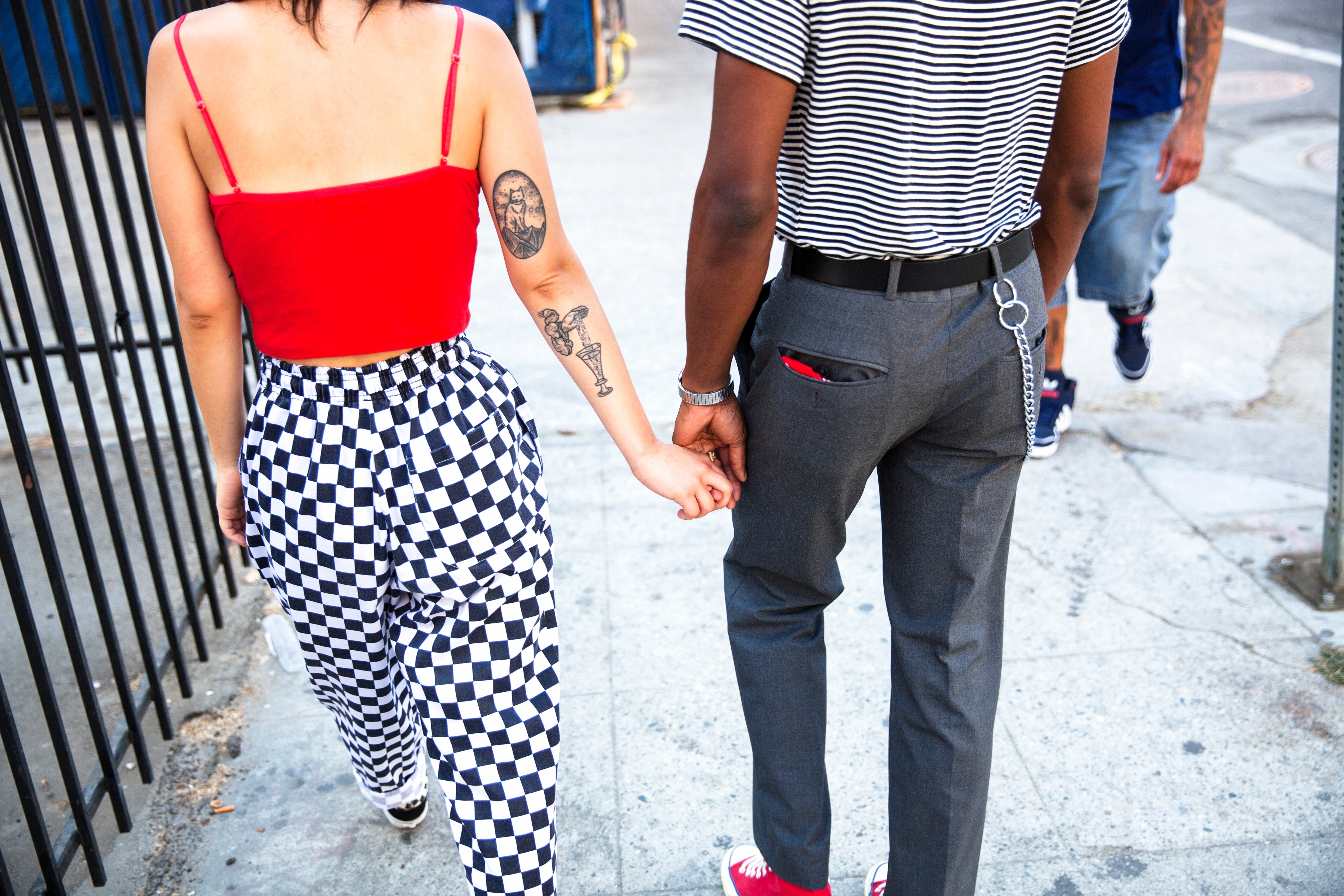 Two people walking hand in hand